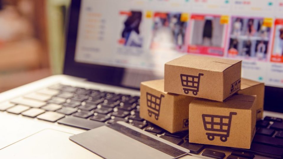 Shopping online concept - Shopping service on The online web. with payment by credit card and offers home delivery. parcel or Paper cartons with a shopping cart logo on a laptop keyboard